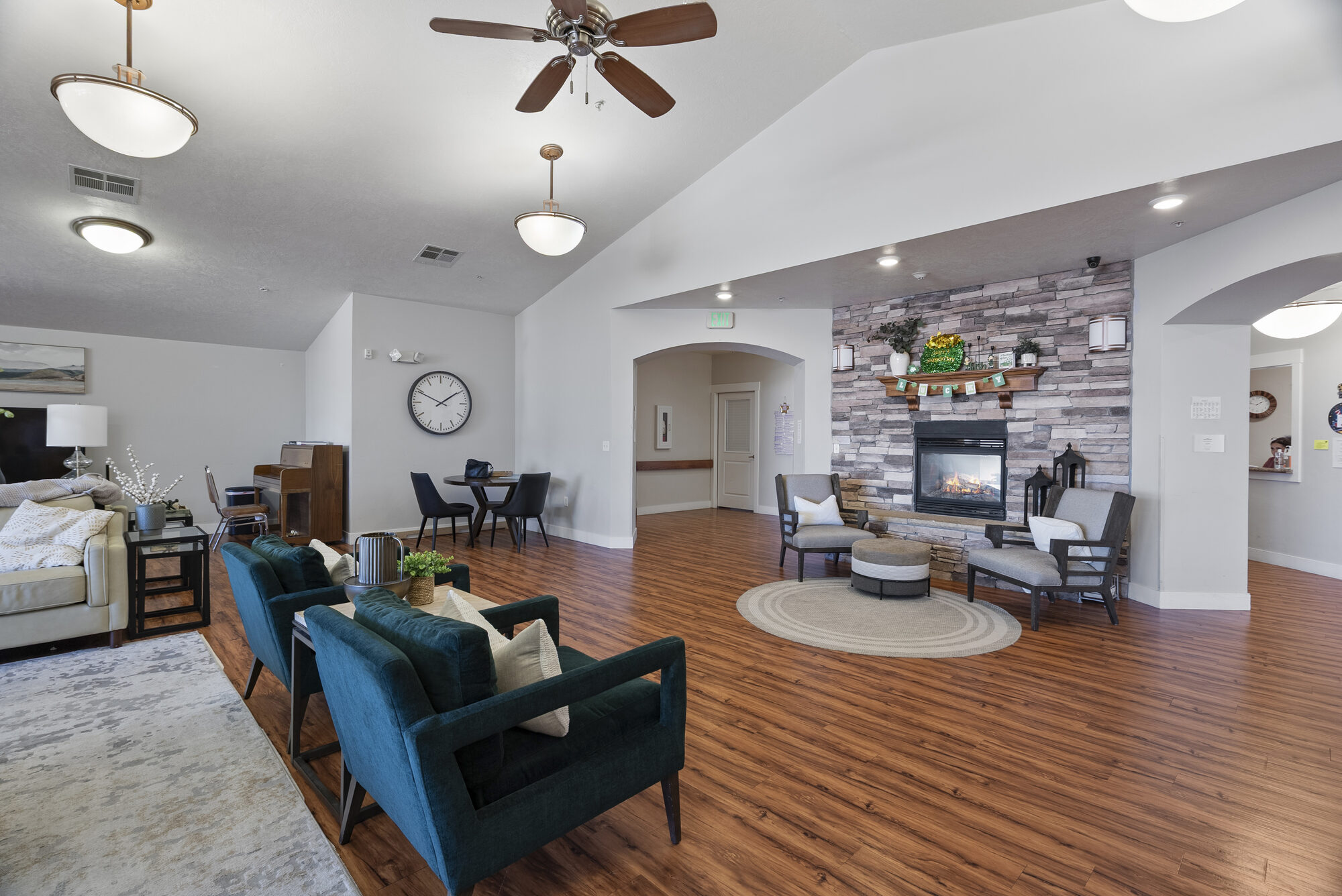 Common area with teal accent chairs at Elk Ridge Assisted Living