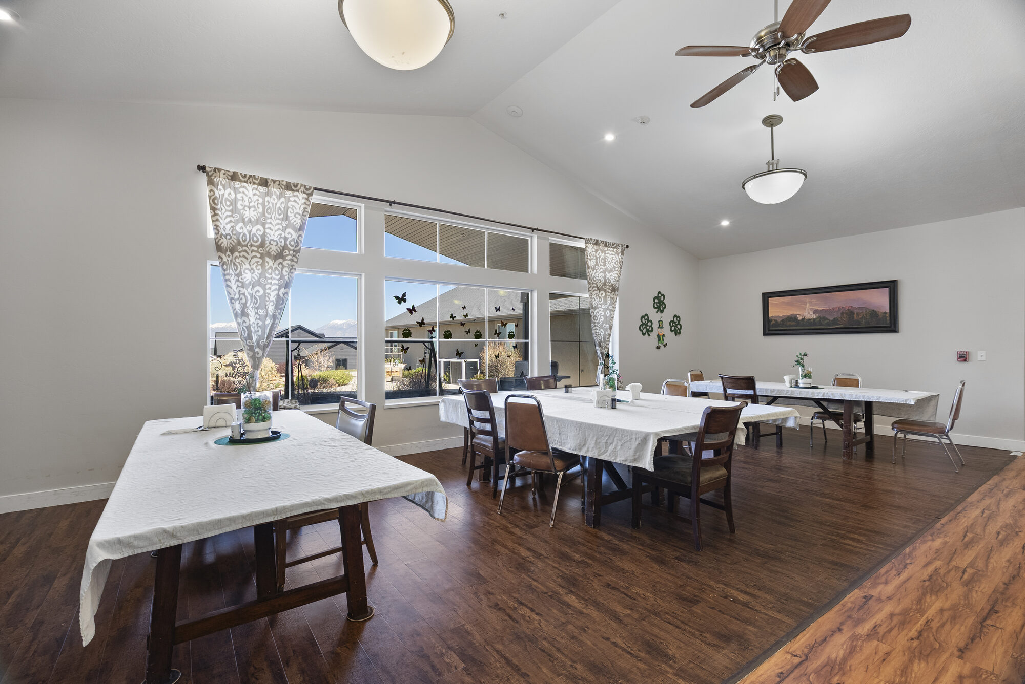 Vaulted dining room with white tablecloths and a wide window framing the Wasatch mountains