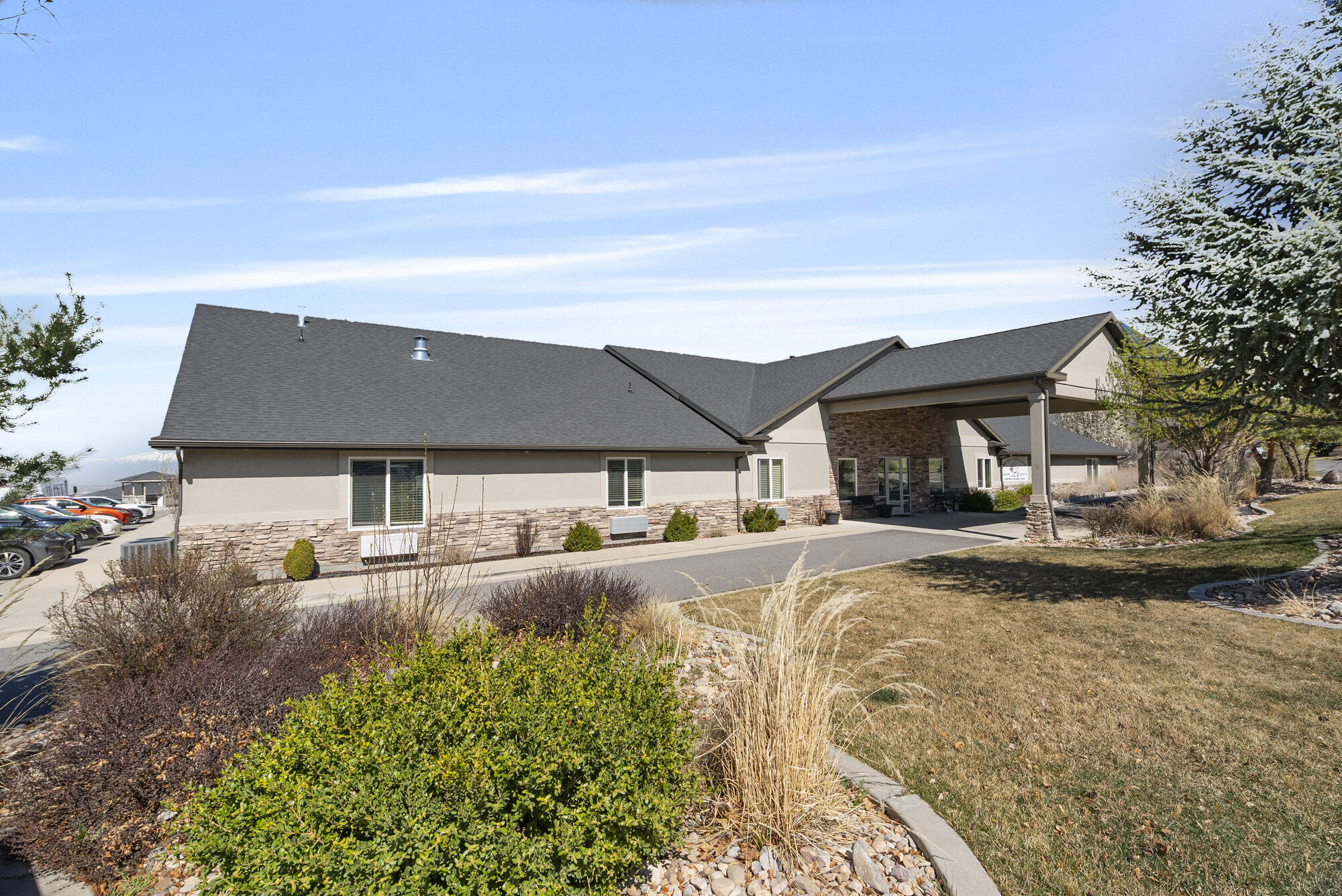 Elk Ridge Assisted Living exterior with the Wasatch mountain ridge in the distance
